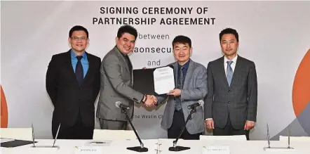  ??  ?? Signed: Ho (second from left) and Lee (third from left) exchanging documents on their partnershi­p agreement as Infinitium marketing director Shawn Tan (left) and Raonsecure executive director for overseas business Kim Changsoo look on.