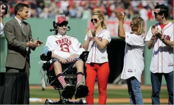  ??  ?? In this April 13, 2015, file photo, Pete Frates, former Boston College baseball player whose Ice Bucket Challenge raised millions for ALS research, is applauded by Boston Red Sox general manager Ben Cherington, far left, and his wife Julie Frates, center, along with other family members prior to the home opener baseball game between the Boston Red Sox and the Washington Nationals at Fenway Park in Boston.