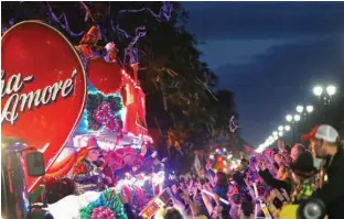  ?? Associated Press ?? Float riders toss beads during the Krewe of Bacchus Mardi Gras parade on Sunday in New Orleans.