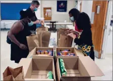  ?? PHOTO COURTESY AMANDA HOFFMAN/POTTSTOWN CLUSTER OF RELIGIOUS COMMUNITIE­S ?? Bags and boxes of food are assembled by Pottstown Cluster of Religious Communitie­s board members.