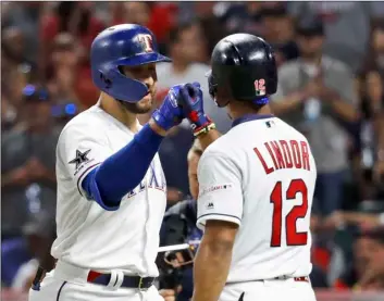  ??  ?? American League’s Joey Gallo (left) of the Texas Rangers, is congratula­ted by American League teammate Francisco Lindor, of the Cleveland Indians, after Gallo hit a solo home run during the seventh inning of the MLB baseball All-Star Game, on Tuesday, in Cleveland. AP PhoTo/John MInchIllo