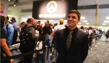  ??  ?? Pro Gamer Jake Lyon, of the Overwatch League's Houston Outlaws, stands outside Overwatch Arena at BlizzCon, where he was interactin­g with fans — a standard part of the job requiremen­ts for many pro esports gamers.