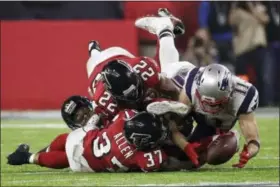  ?? PATRICK SEMANSKY — THE ASSOCIATED PRESS FILE ?? New England Patriots wide receiver Julian Edelman (11) makes a catch as the Atlanta Falcons’ Ricardo Allen and Keanu Neal defend, during the second half of Super Bowl 51 last February in Houston. Down by eight points with about two minutes left, the...