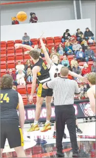  ?? ?? The opening jump Tuesday, Feb. 8, in Blackhawk Arena as the Pea Ridge Blackhawks hosted the Prairie Grove Tigers. Blackhawk junior Evan Anderson (black No. 4) faced against Prairie Grove senior Landon Semrad (black No. 12).