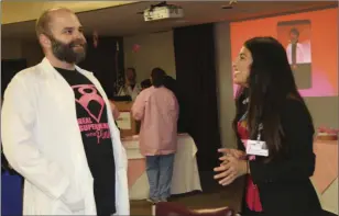  ?? WILLIAM ROLLER PHOTO ?? Joel Birdsong (left) of PMHD at the Real Superheroe­s wear Pink breast cancer awareness event on Thursday.