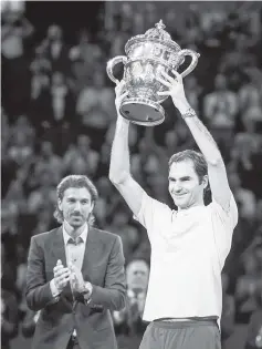  ??  ?? Switzerlan­d’s Roger Federer celebrates as he raises the trophy after his victory against Argentina’s Juan Martin Del Potro in their final game at the Swiss Indoors ATP 500 tennis tournament in Basel. - AFP photo