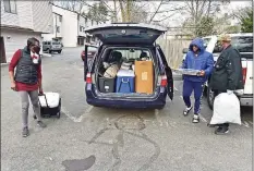  ??  ?? Paul Solomon McDuffie, 54, right, of New Haven, with the help of his wife Jamone, left, and son, Messiyah, cooks food, for free, and travels to feed people in need, especially to the homeless on the New Haven Green.