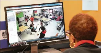  ?? PHOTOS BY CURTIS COMPTON / CCOMPTON@AJC.COM ?? School secretary Louise Paschall monitors a classroom last month at the Taliaferro County School in Crawfordvi­lle with a camera security system that allows views across the campus. There are just 175 students in the Taliaferro school district, smallest...