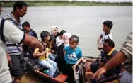  ?? - Reuters ?? DESPERATE: Displaced Iraqis react as they wait to cross the Tigris River by boat after the bridge has been temporaril­y closed, in western Mosul, Iraq, on Saturday.