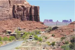  ?? CAROLYN KASTER/ASSOCIATED PRESS ?? A school bus goes through Oljato-Monument Valley, Utah, on the Navajo Nation last month. The Census Bureau has calculated that American Indians and Alaska Natives living on reservatio­ns were undercount­ed at a much higher rate than any other group in the 2010 census.