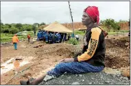  ?? AP/ TSVANGIRAY­I MUKWAZHI ?? Mary Zindege awaits news of her son as rescuers near Kadoma, Zimbabwe, continue the search Sunday for dozens of miners trapped in tunnels fl ooded after heavy rains. As of Sunday, authoritie­s had rescued eight people and found 24 bodies.