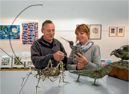  ?? PHOTO: MYTCHALL BRANSGROVE/FAIRFAX NZ ?? Lyttelton artist Martin Cole with Plunket art show committee member Sue Geaney set up Cole’s sculptures made of materials including recycled copper and brass, ahead of the RSM Law Plunket Art Show held at the Aigantighe Art Gallery.