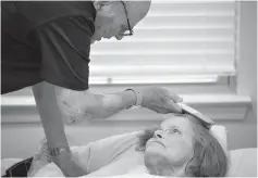  ?? Ashley Landis/Dallas Morning News/TNS ?? ■ Bob Stiegler, 88, brushes the hair of his wife, Norma Stiegler, on Sept. 5 at Sliverado Plano Memory Care Center in Plano, Texas. Bob lives at The Village at Mapleshade and his wife of 58 years, who has dementia, lives next door at Sliverado Plano Memory Care Center.