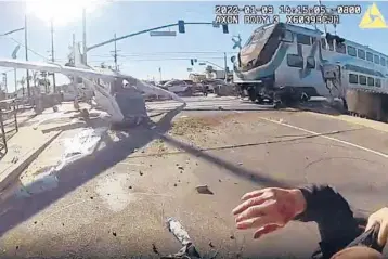  ?? LAPD VIDEO ?? Bodycam footage shows how a pilot of a single-engine plane averted death twice Sunday, first when he crash-landed onto railroad tracks, then when police officers rescued him, bottom right, just before a commuter train smashed into the Cessna 172.
The plane had engine failure after taking off from Whiteman Airport in the Pacoima neighborho­od of Los Angeles.