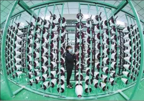  ?? ZHU HAIPENG / FOR CHINA DAILY ?? An employee works on the production line of a glass fiber-reinforced polymer producer in Ganzhou, Jiangxi province.