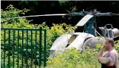  ?? —AFP ?? Police near the helicopter Alouette II abandoned by Redoine Faid after his escape from prison in Reau.