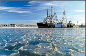  ?? AP/JULIE JACOBSON ?? Surrounded by ice, commercial fishing boats are docked in their slips after more than a week of frigid weather froze the harbor in Lake Montauk in Montauk, N.Y., in January.
