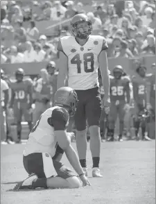  ?? Photo courtesy of Syracuse Athletics ?? Cole Murphy (48), who played soccer and football at Valencia, stands on the field during a game against NC State.