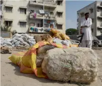  ?? AFP ?? A custom official stands guard beside confiscate­d donkey hides at a warehouse in Karachi on Thursday. —