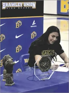  ?? ODETT OCHOA PHOTO ?? Brawley Union High Wildcat Savannah Gomez signs a letter of intent to wrestle at McKendree University on Thursday, March 2, at the Bob Farrell Sports Complex in Brawley.