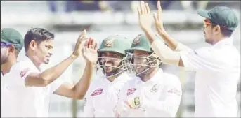  ??  ?? Taijul Islam (left) celebratin­g one of his six wickets