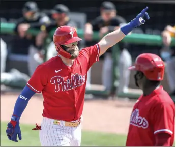  ?? Steven M. Falk /The Philadelph­ia Inquirer /TNS ?? Philadelph­ia Phillies’ Bryce Harper celebrates his two-run home run against the Pittsburgh Pirates during the first inning at Baycare Ballpark in Clearwater, Florida, on March 5.