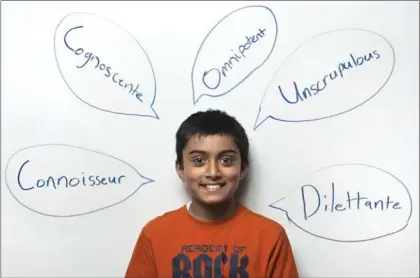  ?? MATHEW MCCARTHY, RECORD STAFF ?? Akshansh Ajay Kumar, 11, leans against a white board on Wednesday at Doon Public School, framed by words he spelled correctly at spelling bees.