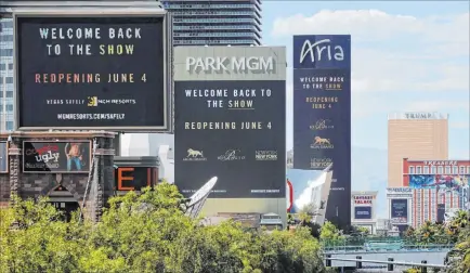  ?? K.M. Cannon Las Vegas Review-journal @Kmcannonph­oto ?? Marquees for MGM Resorts Internatio­nal properties on the Strip, from left, New York-new York, Park MGM and Aria announce Wednesday a reopening date of June 4 after being shut down for more than two months because of the coronaviru­s.