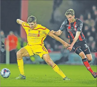  ?? Picture: GETTY IMAGES ?? ON THE WAY TO A WIN: Liverpool’s Steven Gerrard is challenged by Bournemout­h’s Eunan O’Kane during the Capital One Cup quarterfin­al at the Goldsands Stadium