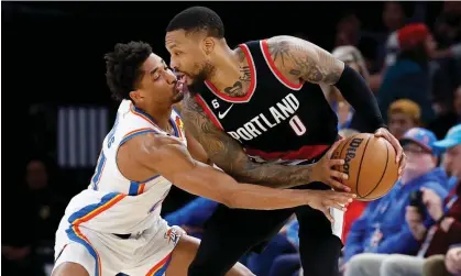  ?? Alonzo Adams/USA Today Sports ?? Portland Trail Blazers guard Damian Lillard (0) is defended by Oklahoma City Thunder guard Aaron Wiggins (21) during the second half of Monday’s game at Paycom Center. Photograph: