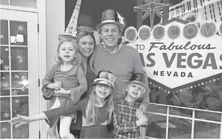  ?? COURTESY PHOTO ?? Abby Adair Reinhard, her husband, Josh, and their three children pose for a family photo during a celebratio­n at home where they pretended to travel to Las Vegas.