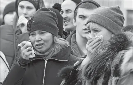  ?? SERGEI GAVRILENKO/AP PHOTO ?? People react Monday after laying flowers for the victims of a fire in a multi-story shopping center in the Siberian city of Kemerovo, about 1,900 miles east of Moscow.