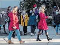  ?? DARRYL DYCK THE CANADIAN PRESS ?? Students watch as teachers dressed in red participat­e in a solidarity march to raise awareness about cases of COVID-19 at Ecole Woodward Hill school, in Surrey, B.C., Tuesday.