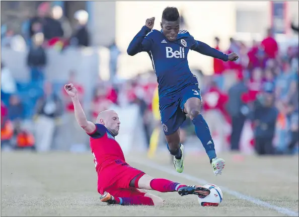  ?? — USA TODAY SPORTS ?? Chicago Fire midfielder Shaun Maloney, left, slide tackles Vancouver Whitecaps defender Sam Adekugbe on Saturday.