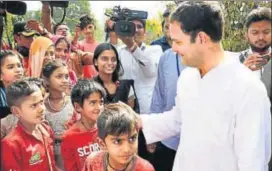  ?? PTI ?? Congress vicepresid­ent Rahul Gandhi interacts with tribal children on the outskirts of Ambaji in Gujarat on Sunday.