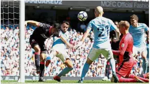  ??  ?? No way: Huddersfie­ld’s Christophe­r Schindler clears the ball off the line during the English Premier League match against Manchester City yesterday. — Reuters