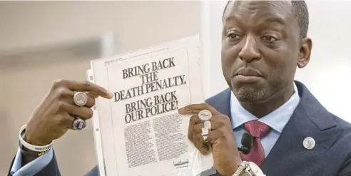  ?? MICHAEL GARD/POST-TRIBUNE ?? Yusef Salaam, one of the exonerated Central Park Five, displays a full-page ad taken out in 1989 by Donald Trump in The New York Times. Salaam spoke at Purdue University Northwest in Hammond on Sept. 22.