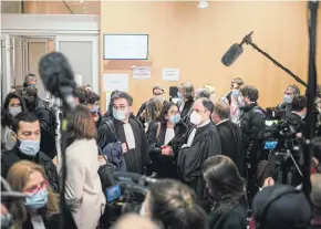  ??  ?? People outside a courtroom after the verdict of the trial that found 14 people guilty of aiding in the 2015 attack on ‘Charlie Hebdo’ in Paris, on Dec 16.