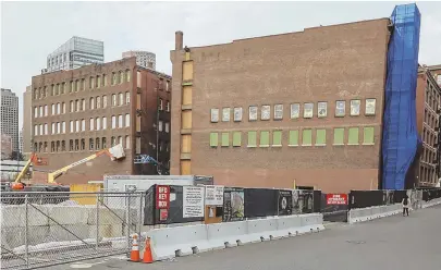  ?? STAFF PHOTO BY NICOLAUS CZARNECKI ?? LAYOFFS ANNOUNCED: The building at Necco Street and Necco Court is being converted into part of the General Electric headquarte­rs campus at Fort Point in Boston. CEO John Flannery, top, said previously the company is cutting $1 billion in costs this...