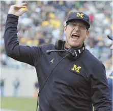  ?? AP PHOTO ?? PUMPED AND JACKED: Michigan coach Jim Harbaugh reacts during the fourth quarter of yesterday’s win over Michigan State in East Lansing, Mich.