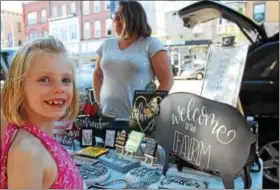  ?? MICHILEA PATTERSON — DIGITAL FIRST MEDIA ?? Fiona Ross, 6, smiles for the camera while standing in front of an artisan vendor table during the outdoor farmers market in Pottstown on Thursday. The market will be in the 200 block of E. High St. every Thursday from 5 to 7:30 p.m.