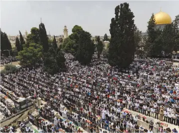  ??  ?? PEOPLE GATHER for Ramadan prayers in Jerusalem.