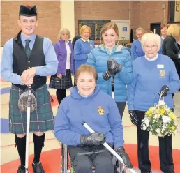  ??  ?? Four stars Paralympia­n Aileen Neilson is pictured with (from left) piper Jay Wilson, Hazel Smith who swept the first stone, and Meg Allan, who threw the first stone on the day