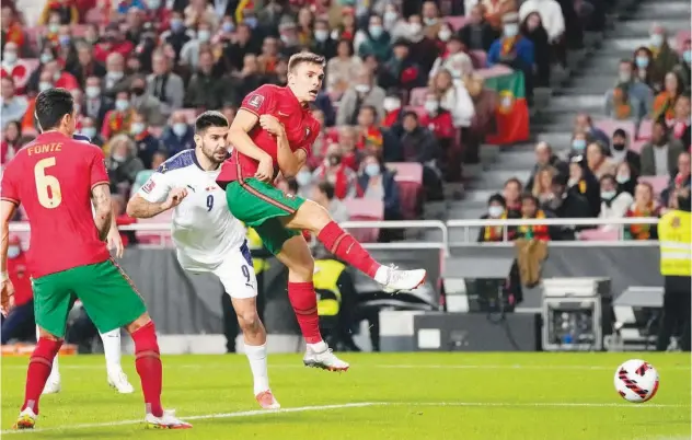  ?? Associated Press ?? ↑
Serbia’s Aleksandar Mitrovic (second left) scores a goal against Portugal during their World Cup 2022 Group A qualifying match in Lisbon on Sunday.