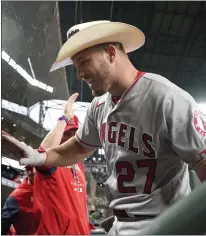  ?? TED S. WARREN – THE ASSOCIATED PRESS ?? The Angels' Mike Trout wears a cowboy hat in the dugout after he hit a solo home run against the Mariners in Game 2of the doublehead­er.