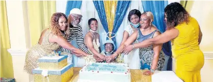  ??  ?? Ethlin Blake gets plenty of help to cut her birthday cake. Assisting are (from left) grandniece Nadine Hemmings-Gray, nephew Victor Abrahams, adopted daughter Dawnetta Seymour, niece Pauline Hemmings, and granddaugh­ters Jennifer Hemmings and Winsome Hemmings-Thompson.