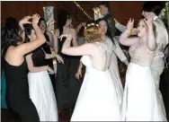  ?? Photo by Mike Eckels ?? (Above photo) A group of girls do the zombie walk to Michael Jackson’s “Thriller” during the Decatur High School Prom in the hall at Horton Farms near Decatur. (Center photo) Cheyenne Malone, Meagan Smith (back), Timothy Skaggs and Kallisto Gonzalez take a moment to pose for pictures during the prom.