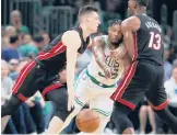  ?? MICHAEL DWYER/AP ?? Bam Adebayo screens the Celtics’ Marcus Smart as Tyler Herro drives during the Heat’s win in Game 3 of the Eastern Conference finals Saturday in Boston.