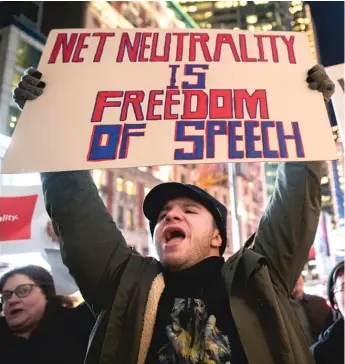  ?? MARY ALTAFFER/AP FILE ?? Demonstrat­ors rally in support of net neutrality outside a Verizon store in New York in December. California Gov. Jerry Brown has approved the nation’s strongest net neutrality law, prompting an immediate lawsuit by the Trump administra­tion and opening the next phase in the battle over regulating the internet.