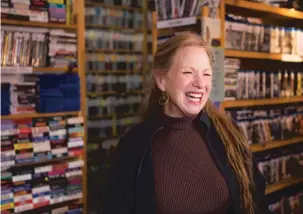  ?? OLIVIA HARLOW/NEW MEXICAN FILE PHOTO ?? Lisa Harris, co-owner of Santa Fe’s Video Library, laughs with customers inside the rental store last month. When you walk into the Video Library, be prepared to not only pick up the movie you were looking for but to also enter into lively coffee-house conversati­on about your life, your world and your dog.